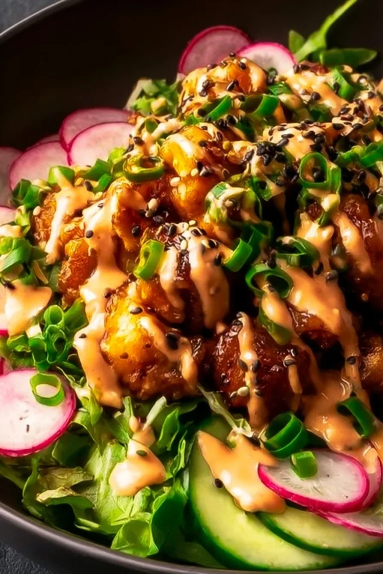 A delicious bowl of Bang Bang Chicken served with fresh vegetables and rice.