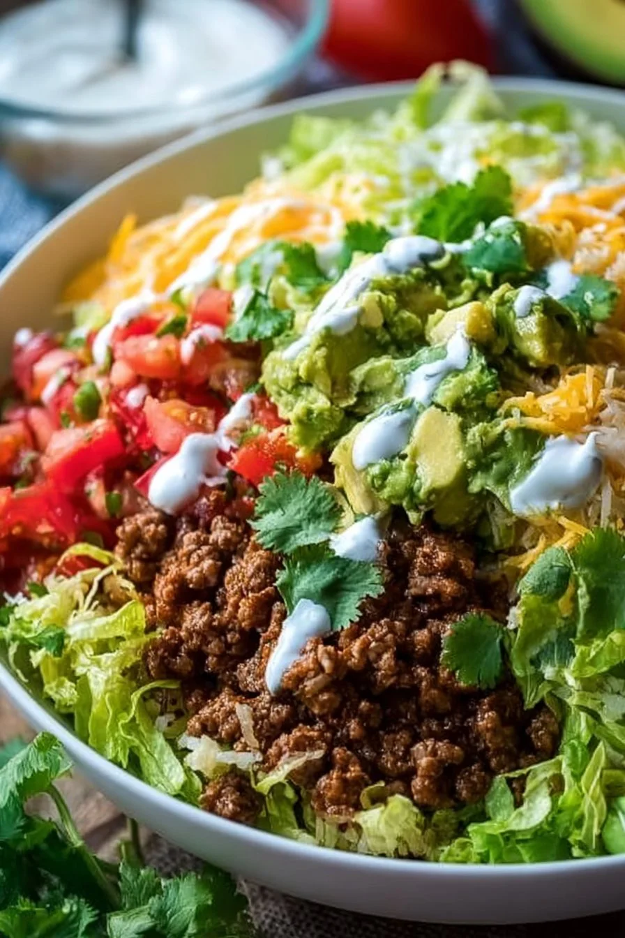 A colorful low carb burrito bowl filled with fresh vegetables and proteins