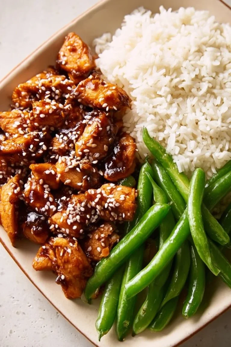 Healthy high protein sesame chicken dish garnished with sesame seeds