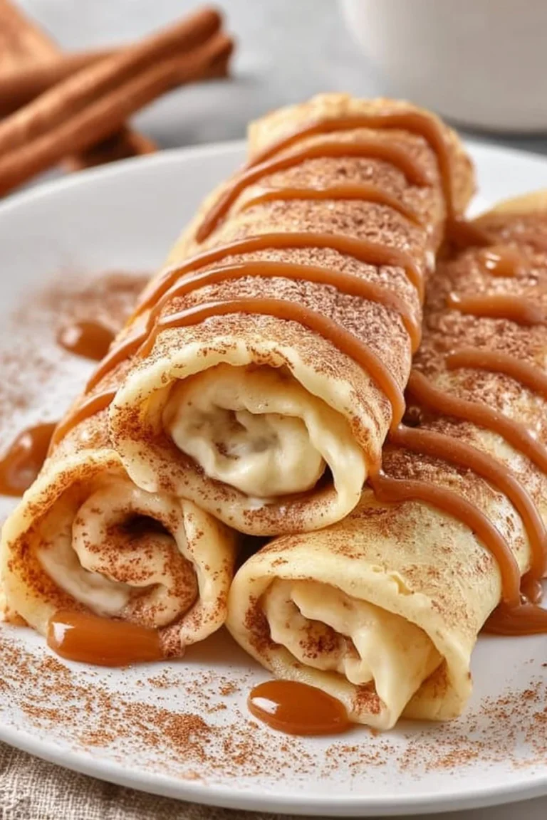 Cinnamon roll protein crepes with frosting and cinnamon topping